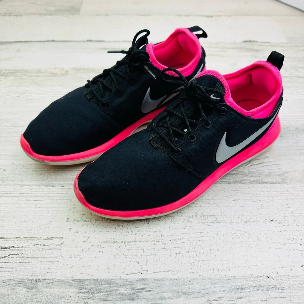 Black and hot pink Nike running shoe